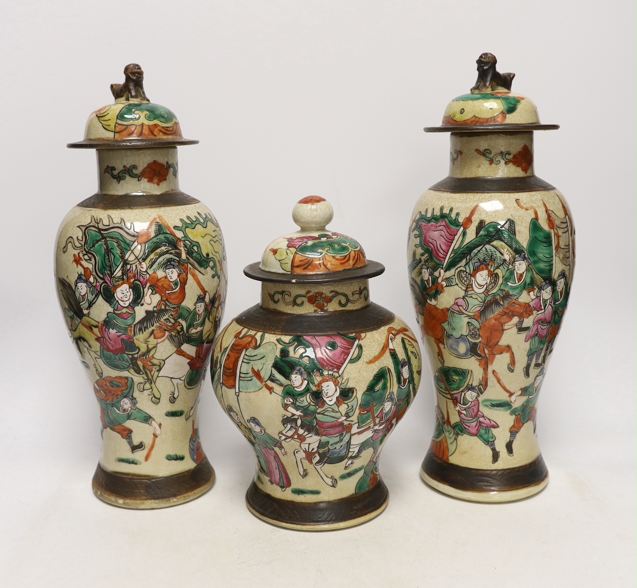 Three various Chinese crackleware famille rose jars and covers including a baluster example, largest 35cm high